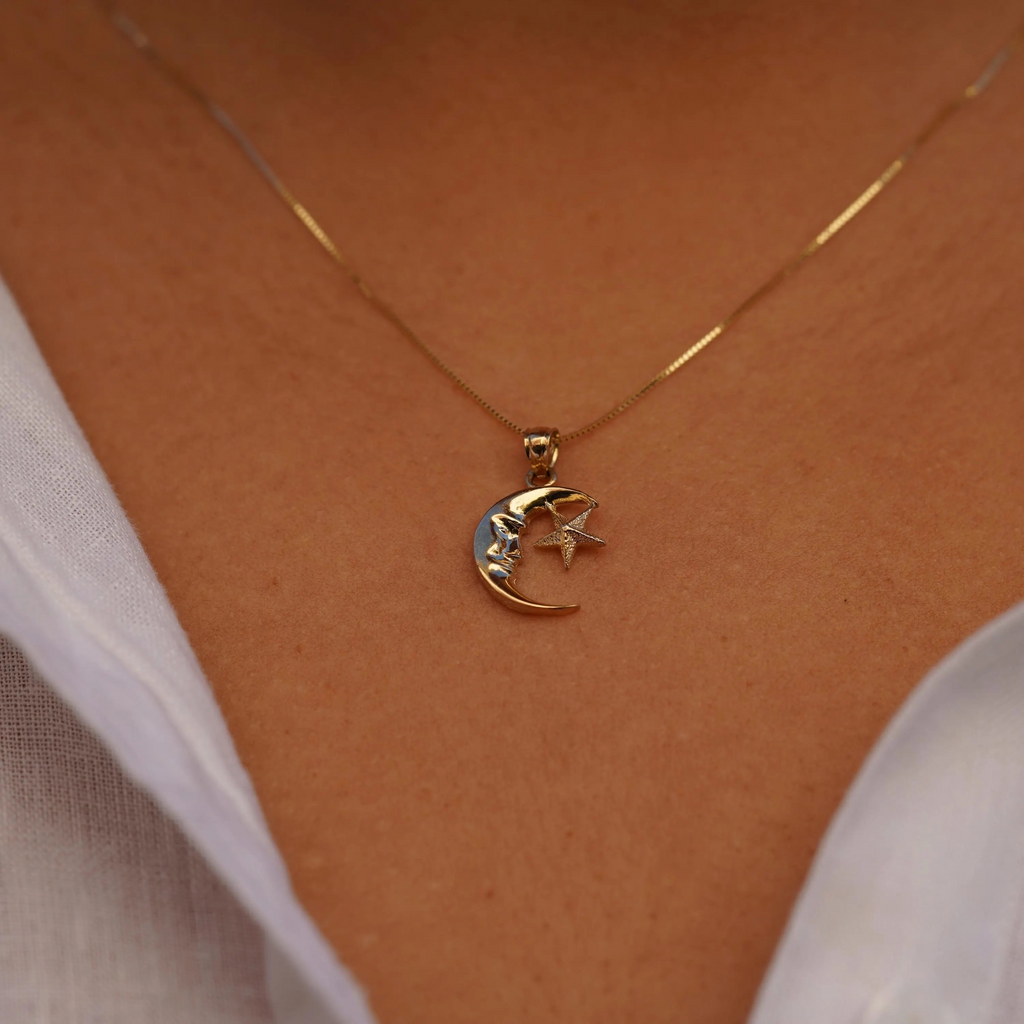 Model wearing the 14K Gold Moon & Star Pendant, showcasing its elegant fit and how it complements the overall look from a slightly distant perspective.