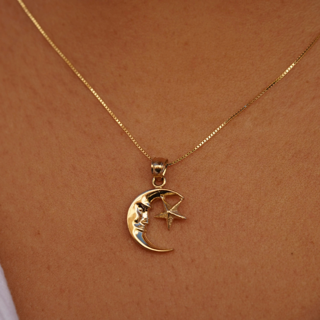 Close-up of a model wearing the 14K Gold Moon & Star Pendant, highlighting its delicate crescent moon and star design and polished yellow gold finish.