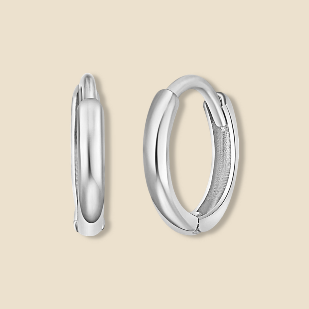 14K Gold Small Plain Huggie Earrings in white gold displayed on a plain background, highlighting their minimalist design, polished finish, and dainty 8 mm size.