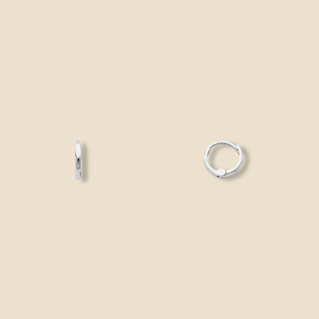 14K Gold Small Plain Huggie Earrings in white gold displayed on a plain background, highlighting their minimalist design, polished finish, and dainty 8 mm size.