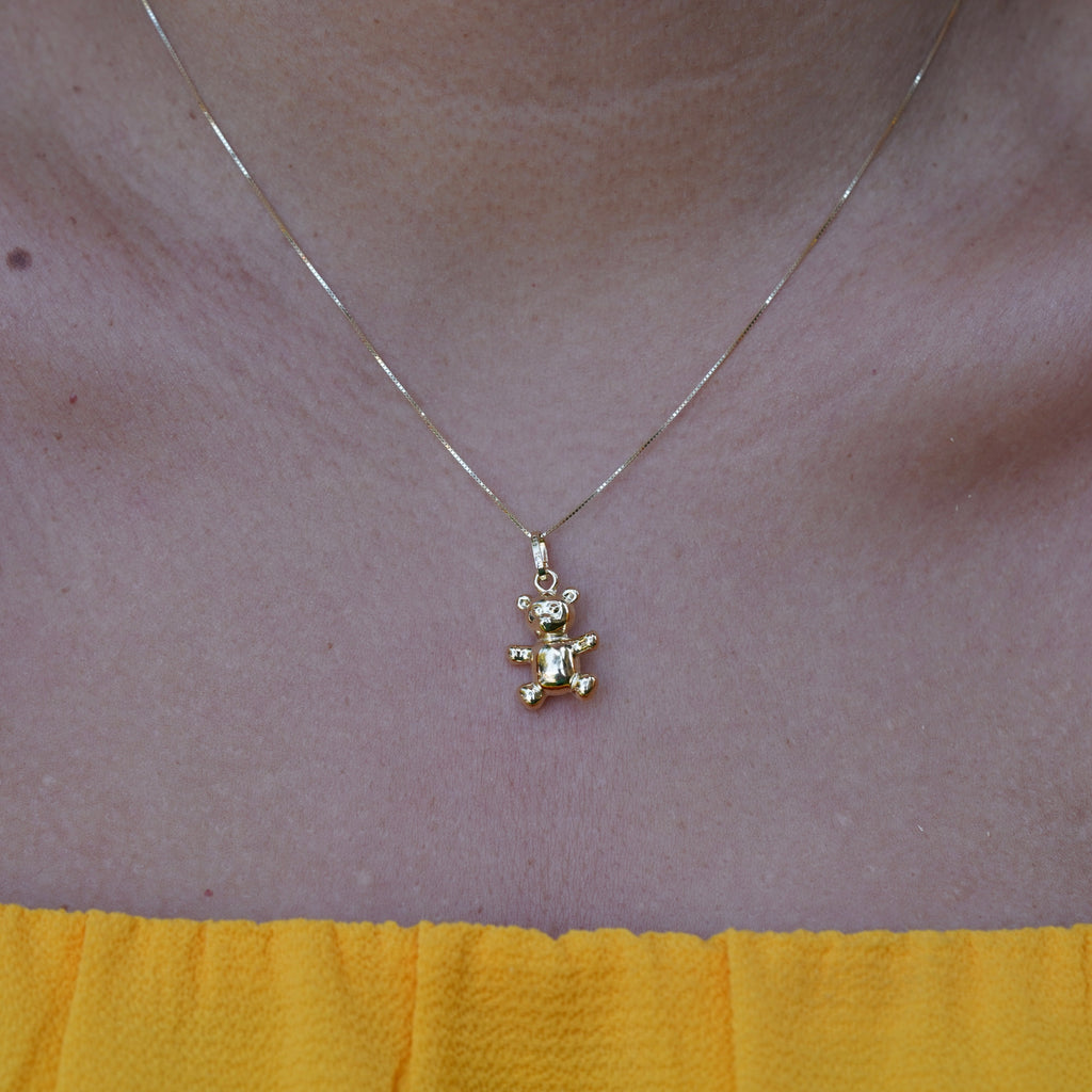 Model showcasing the 14K Real Gold Bear Pendant, worn as a necklace, with a front-facing view that emphasizes its elegant and dainty design.